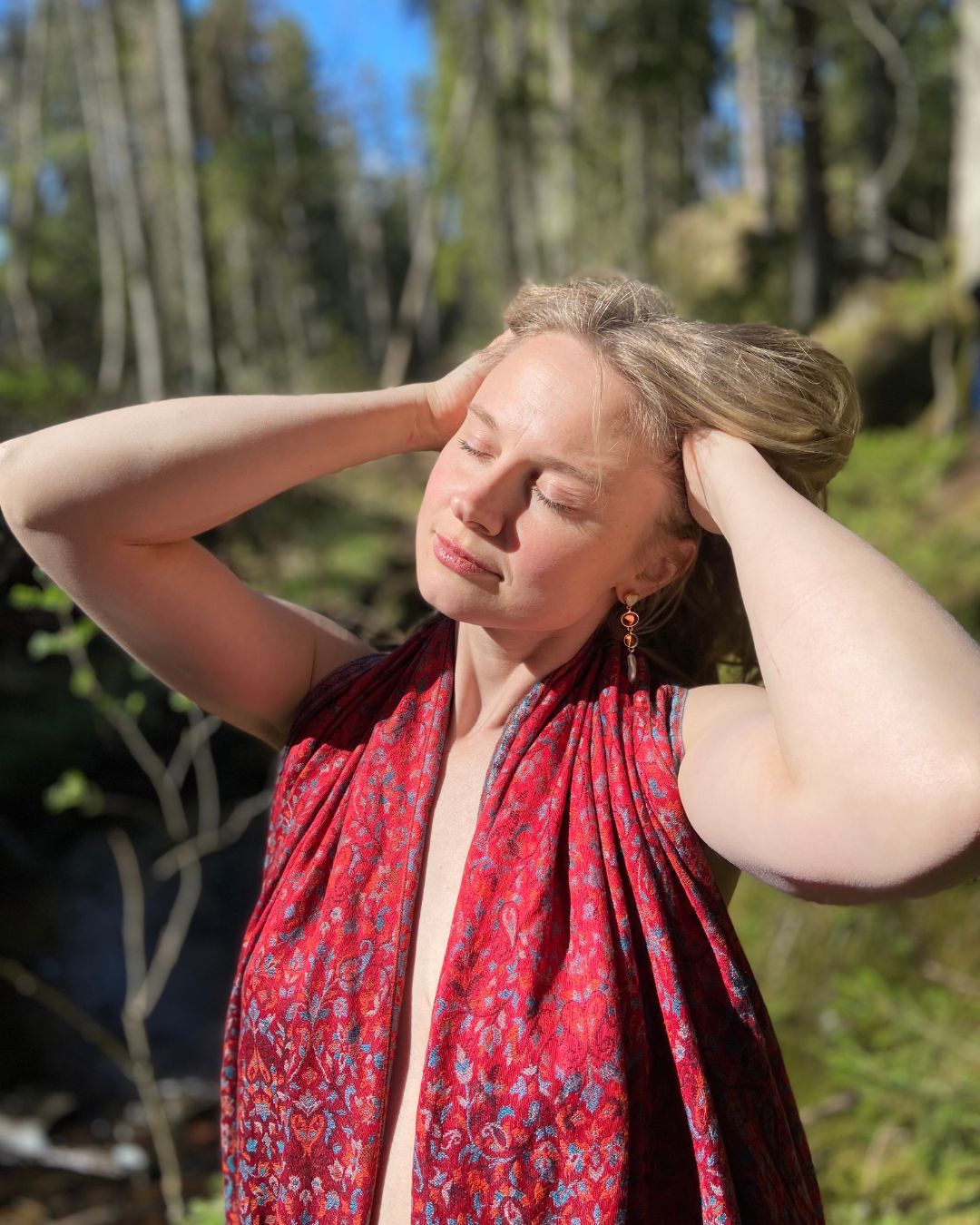 Anna Ma with eyes closed, turned towards the sunlight